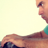 Bald man looking at the laptop computer