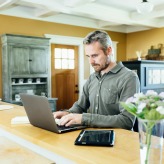 man working using laptop at home
